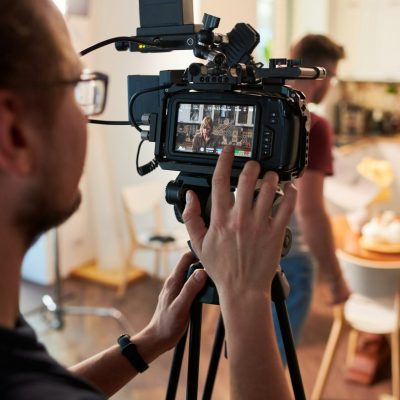 contemeporary-videographer-or-cameraman-adjusting-video-camera-options.jpg