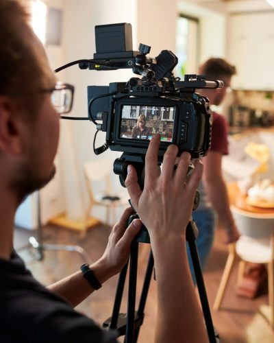 contemeporary-videographer-or-cameraman-adjusting-video-camera-options.jpg