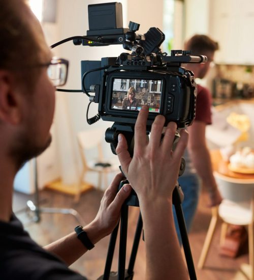 contemeporary-videographer-or-cameraman-adjusting-video-camera-options.jpg