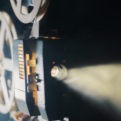 film projector on a black background with dramatic lighting and selective focus
